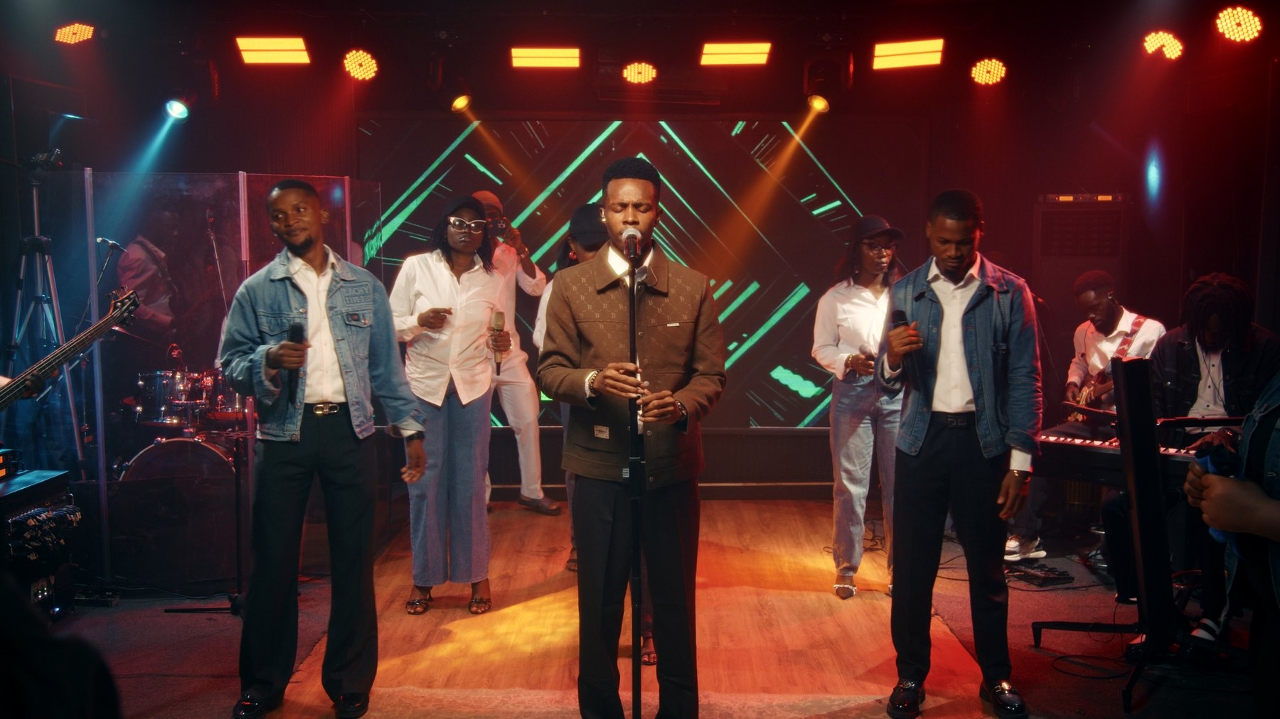 NWELL centre stage with his band and choir during the 9 August 2026 live recording.