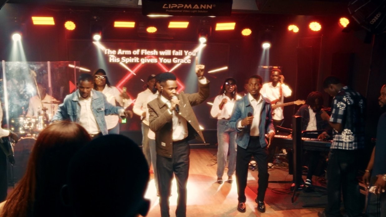 NWELL and the choir as the lyric wall reads: The Arm of Flesh will fail You, His Spirit gives You Grace.